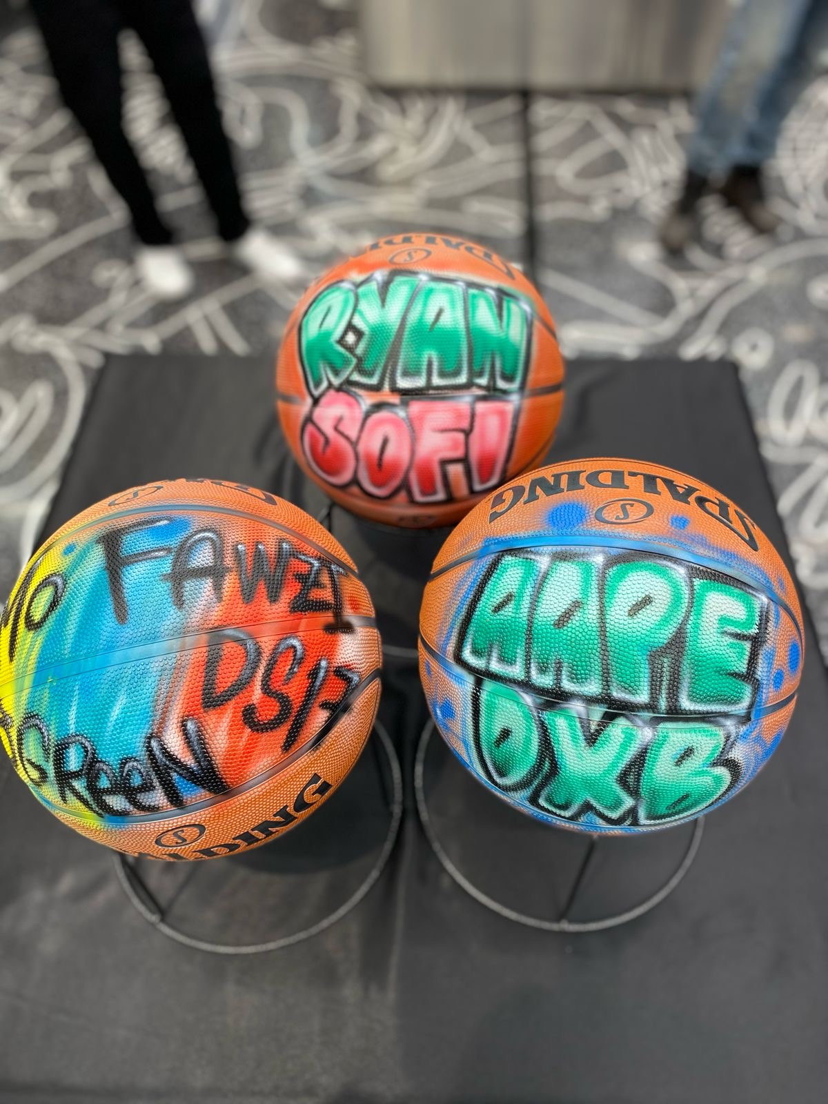 Ella airbrushing a basketball in store