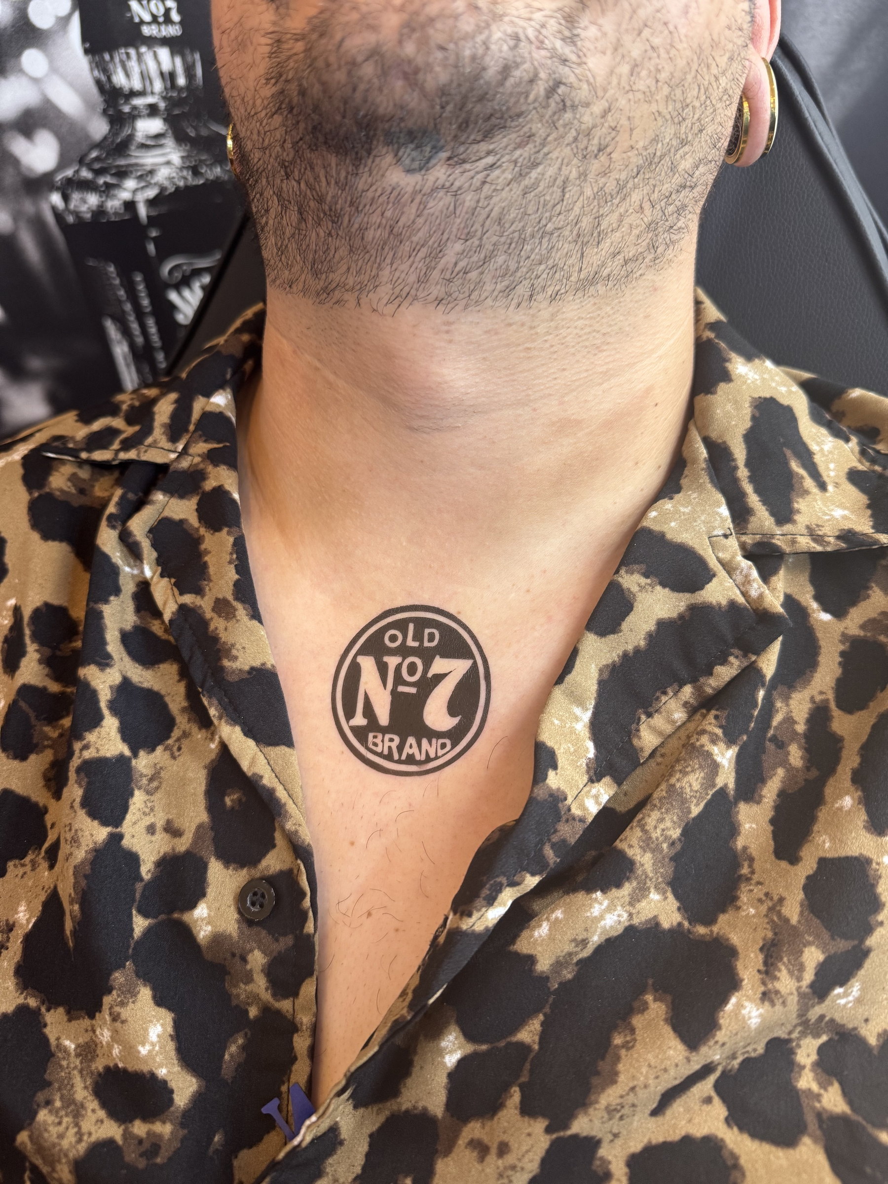 Airbrushed logo tattoo on a shoulder