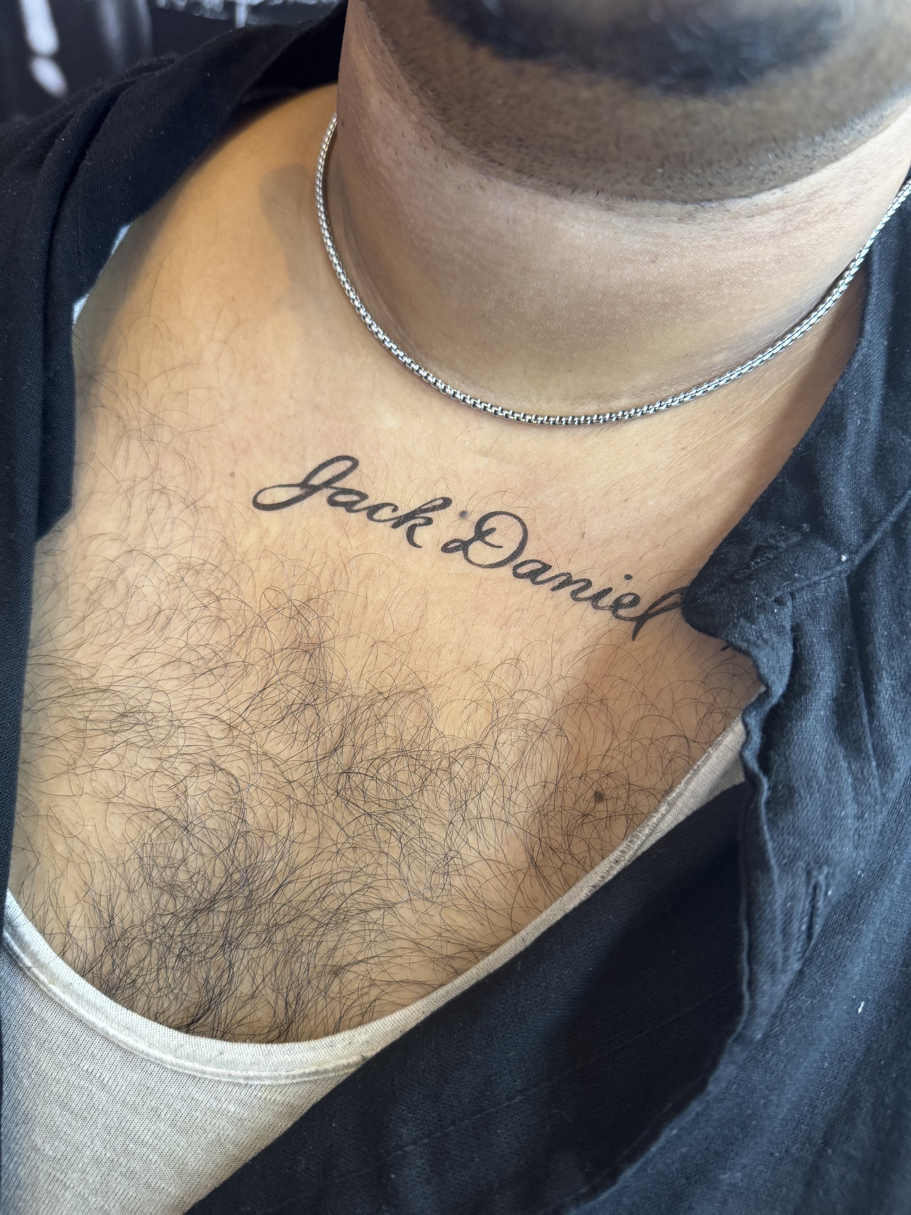 Airbrushed script tattoo on a chest