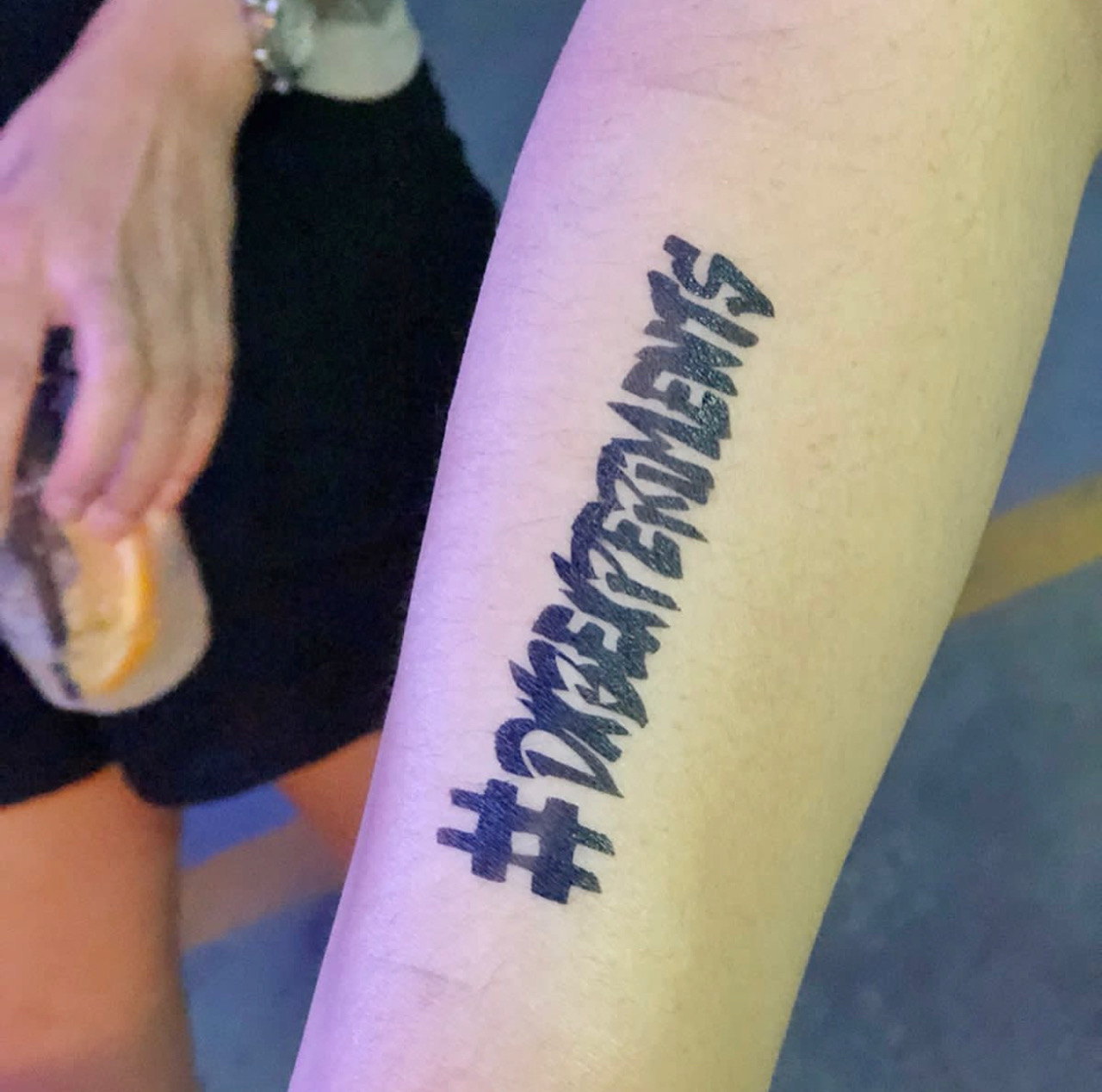 Airbrushed hashtag lettering on a forearm