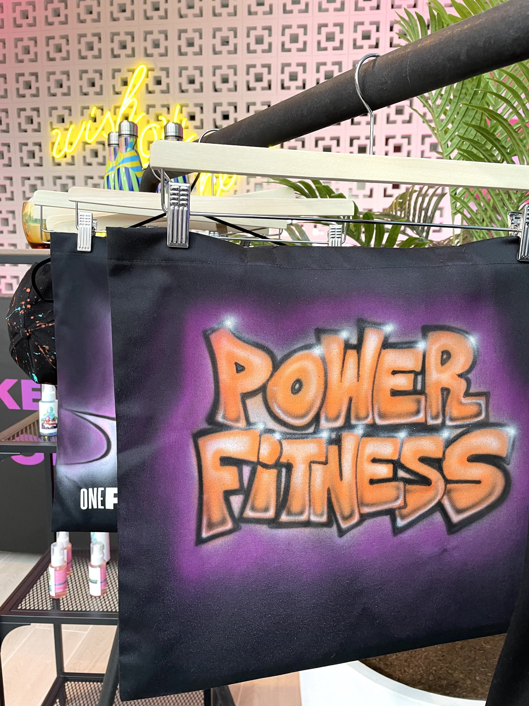 'Power Fitness' airbrushed on a black tote bag