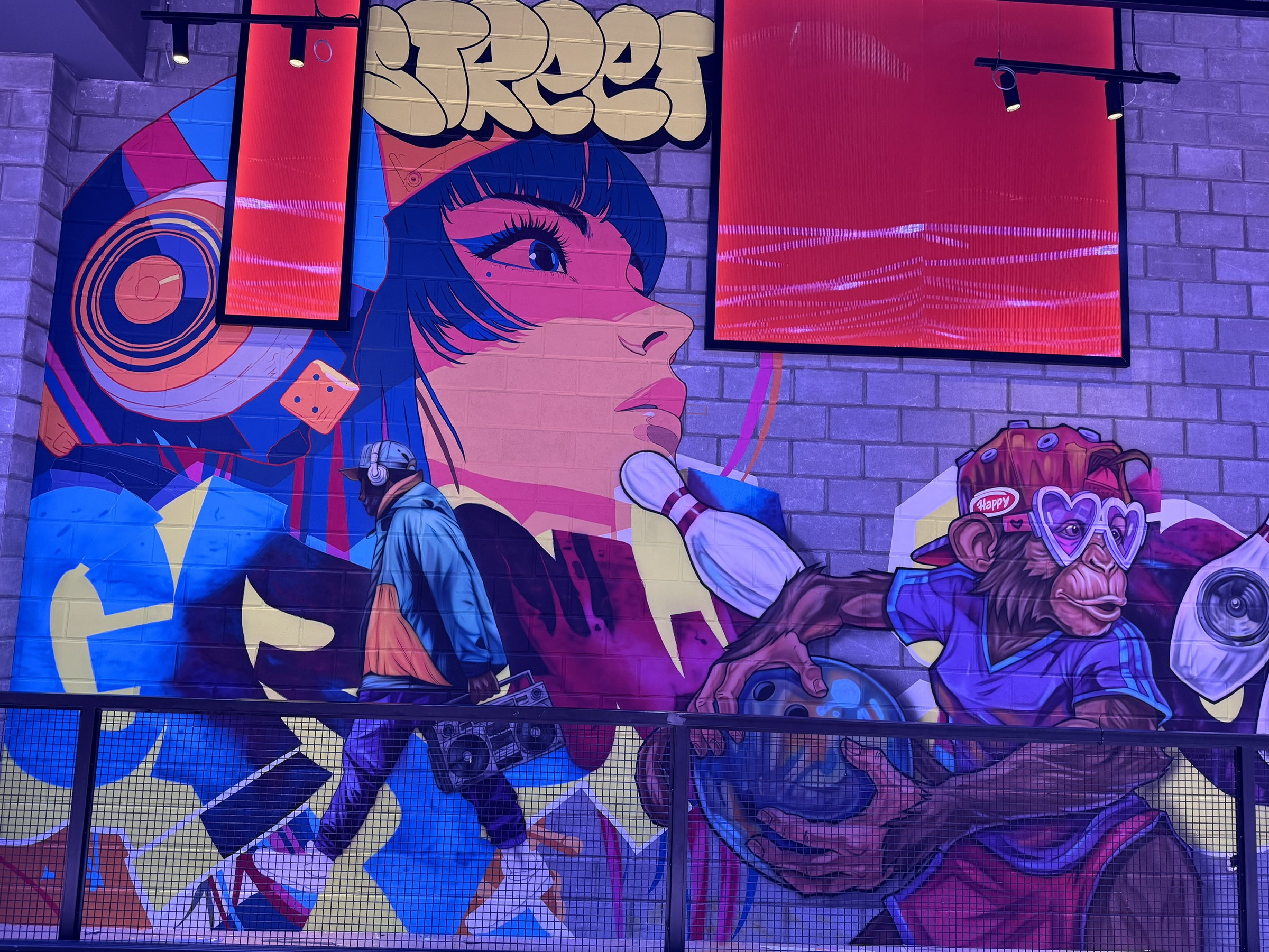 Monkeys in shades with a boombox, painted across the wall
