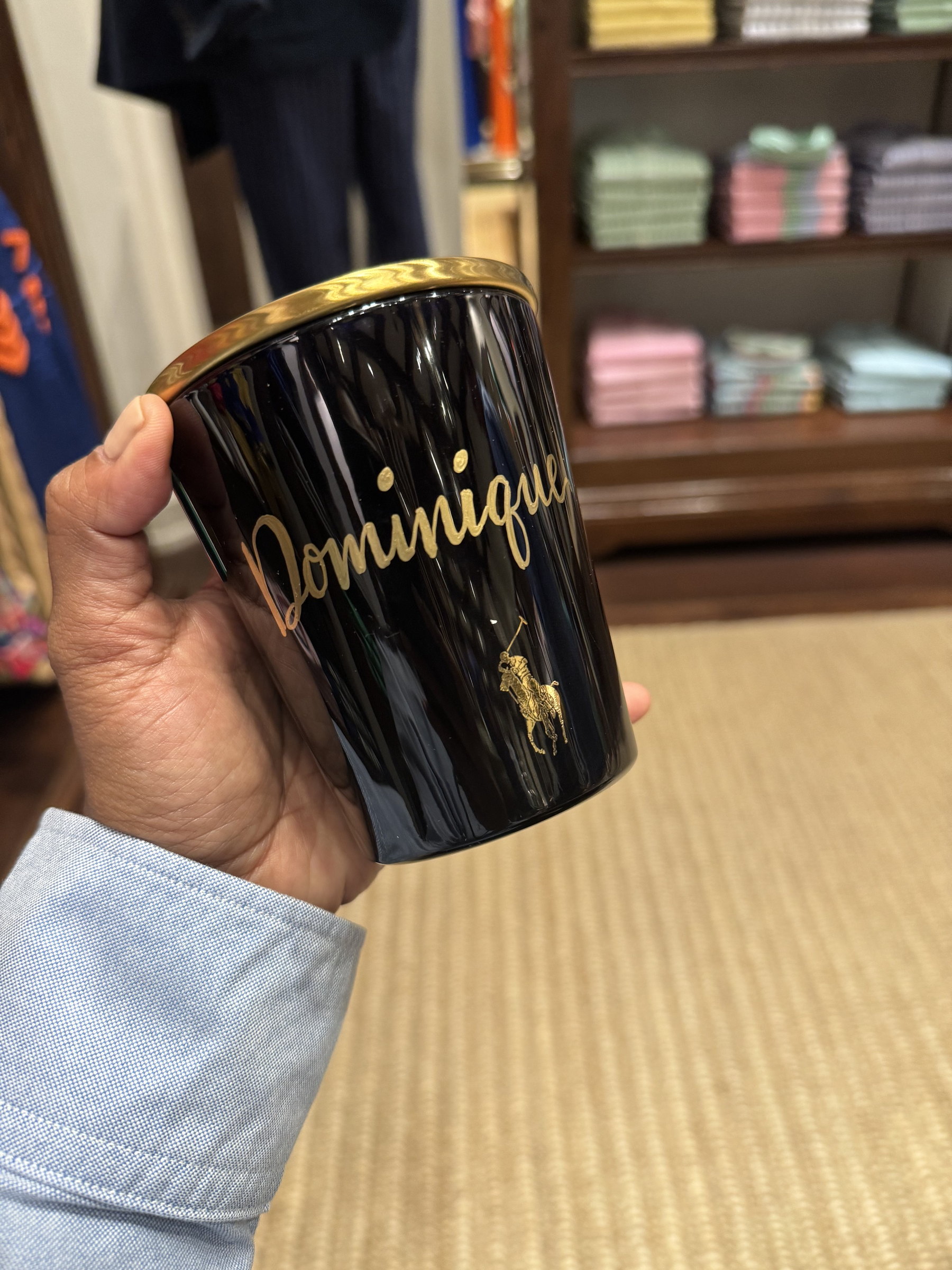 'Dominique' lettered in gold on a candle jar