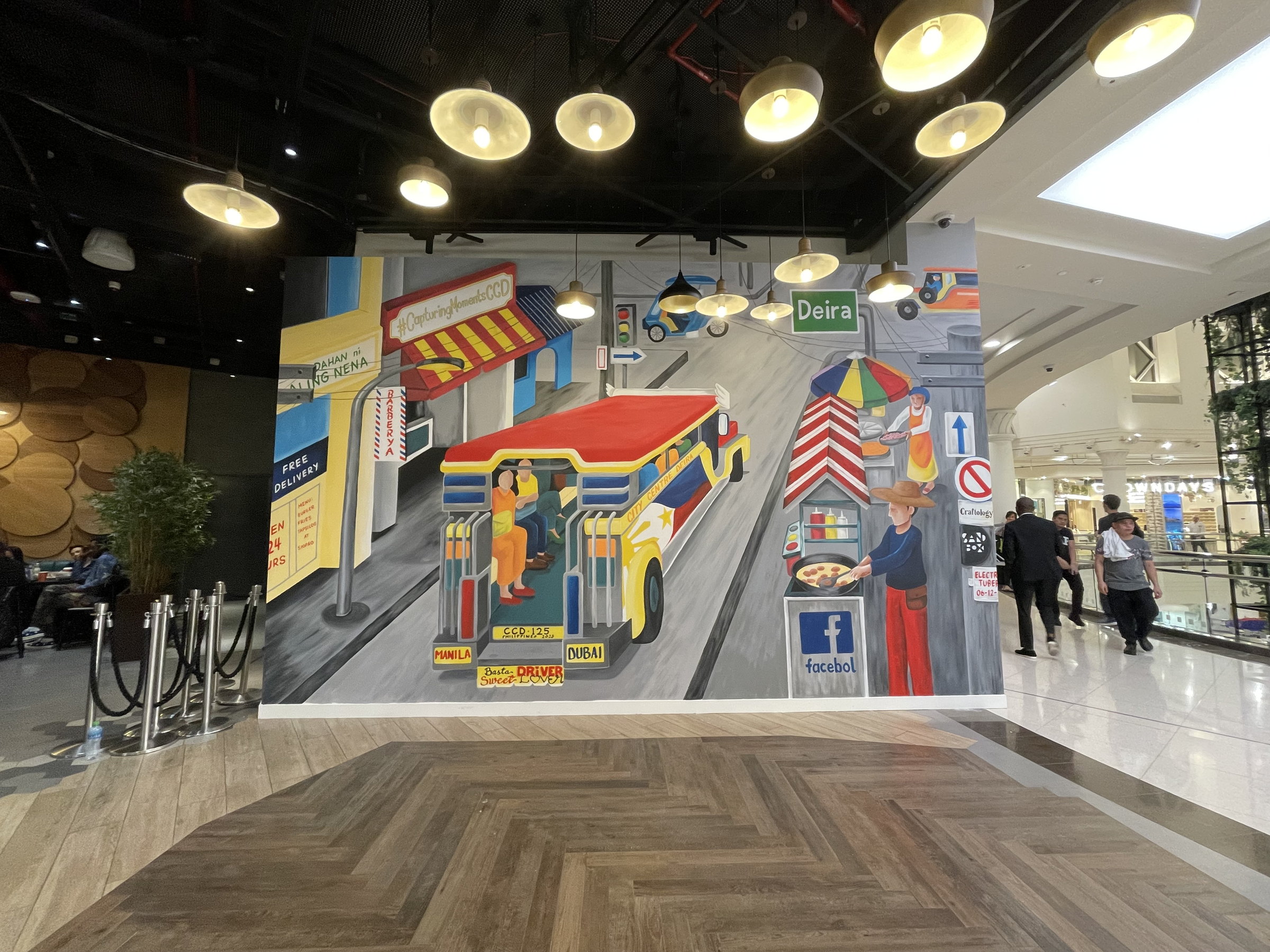 Colourful street-scene mural painted live at City Centre Deira