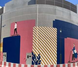 Visitors beneath the Dubai Hills Mall mural
