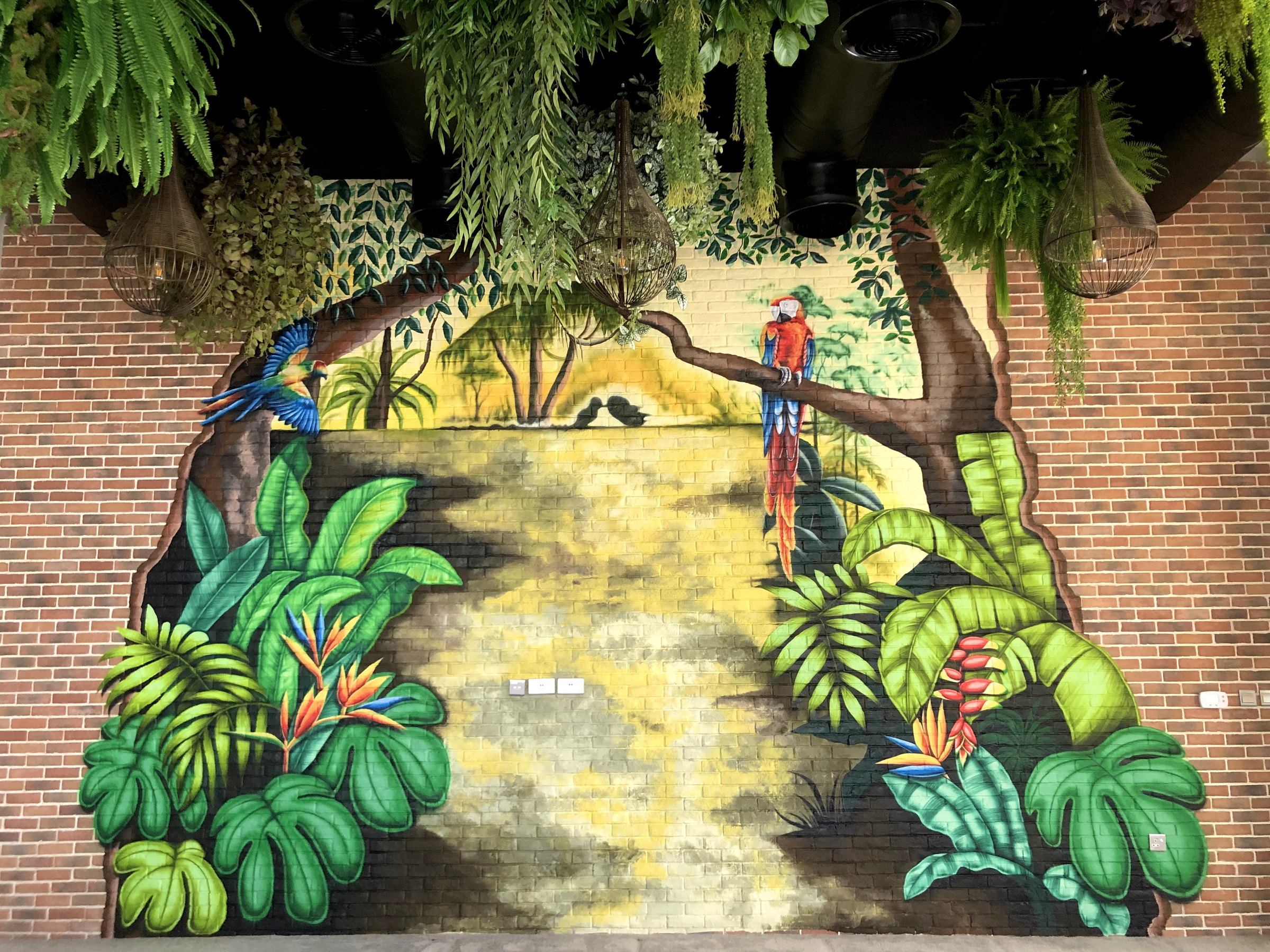 Jungle mural with a sunlit path in a villa entertainment lounge