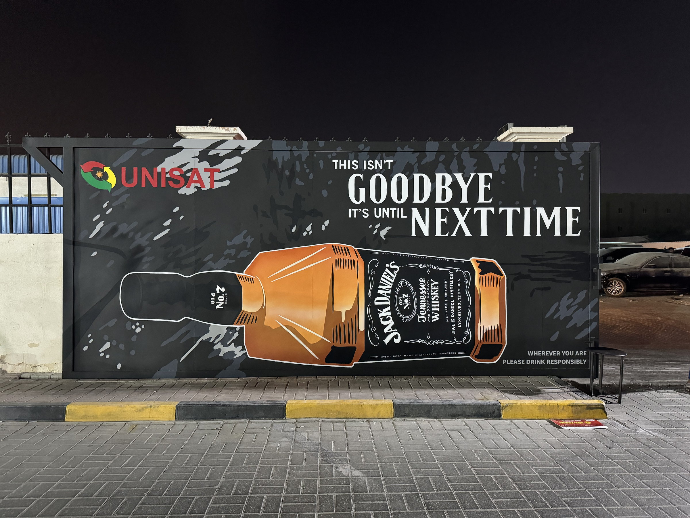 Jack Daniel's bottle and 'Goodbye, it's until next time' wall at Unisat, Ajman