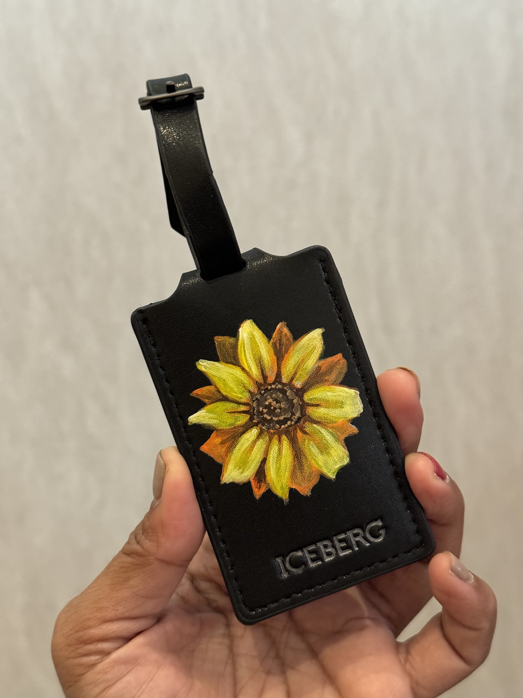 Sunflower painted on a black leather luggage tag