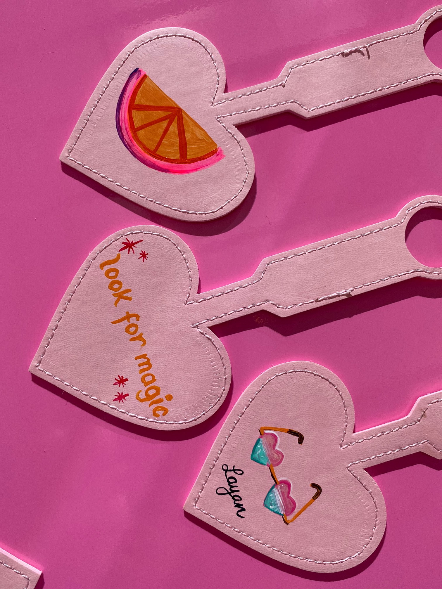 Pink heart-shaped tags with hand-lettering