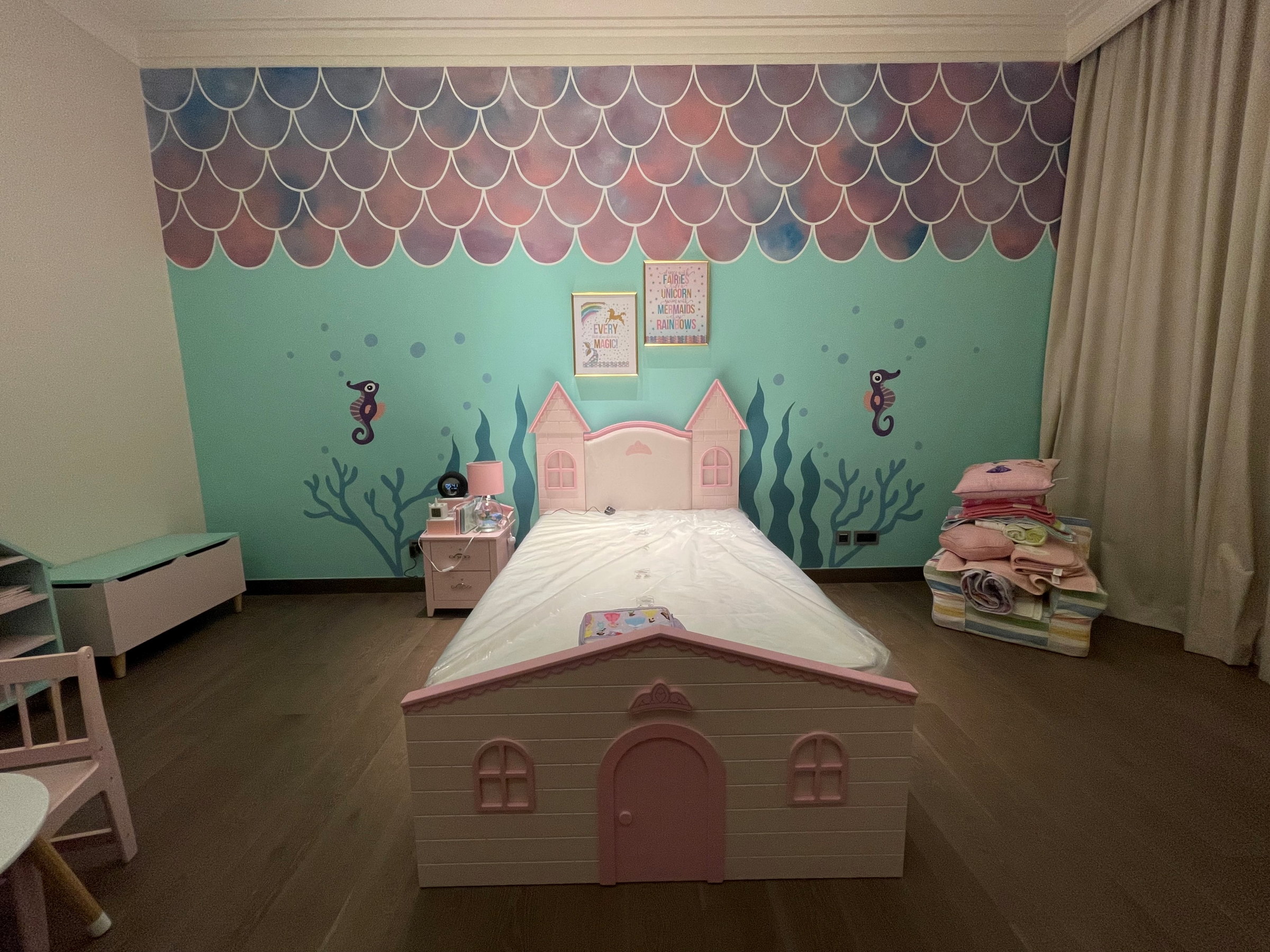 Mermaid-themed bedroom with painted scales and a cottage bed