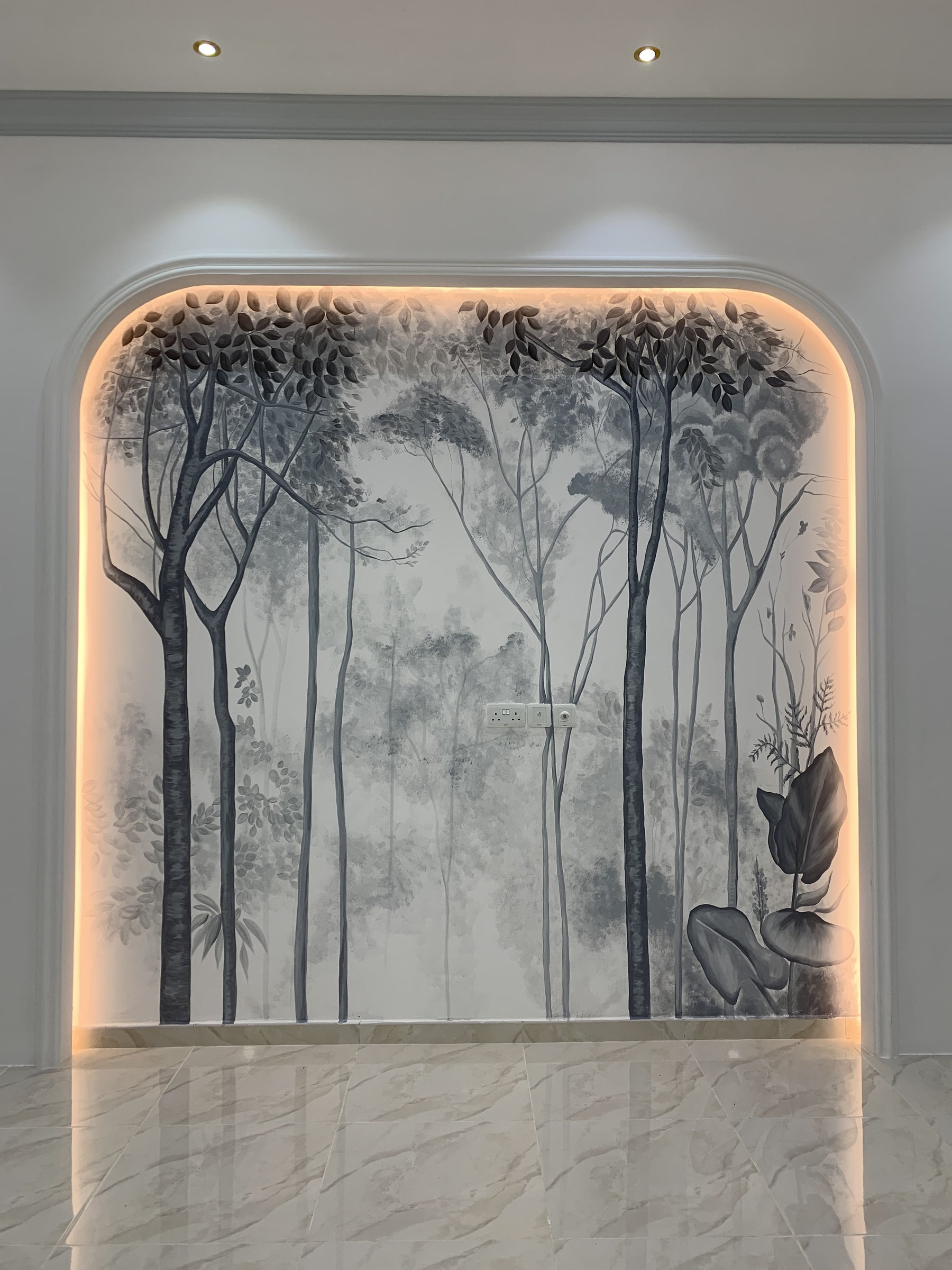 Grey forest painted on an arched wall, lit from the edges