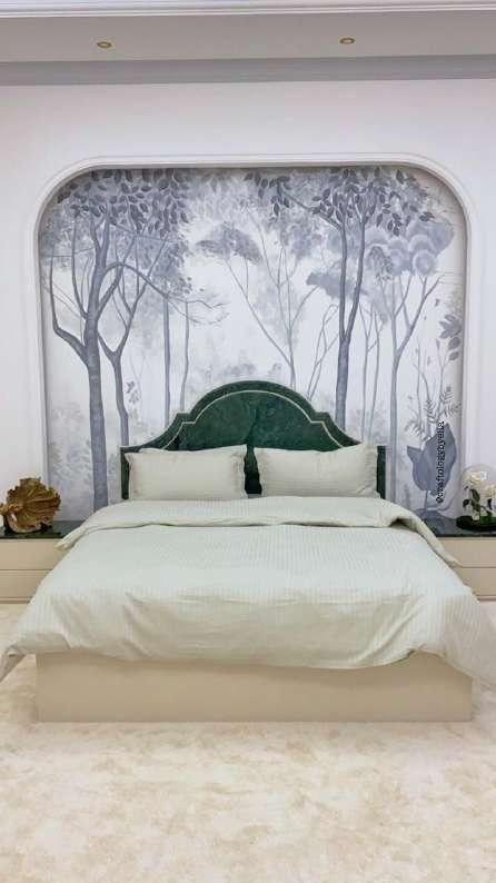 Forest mural behind a bed