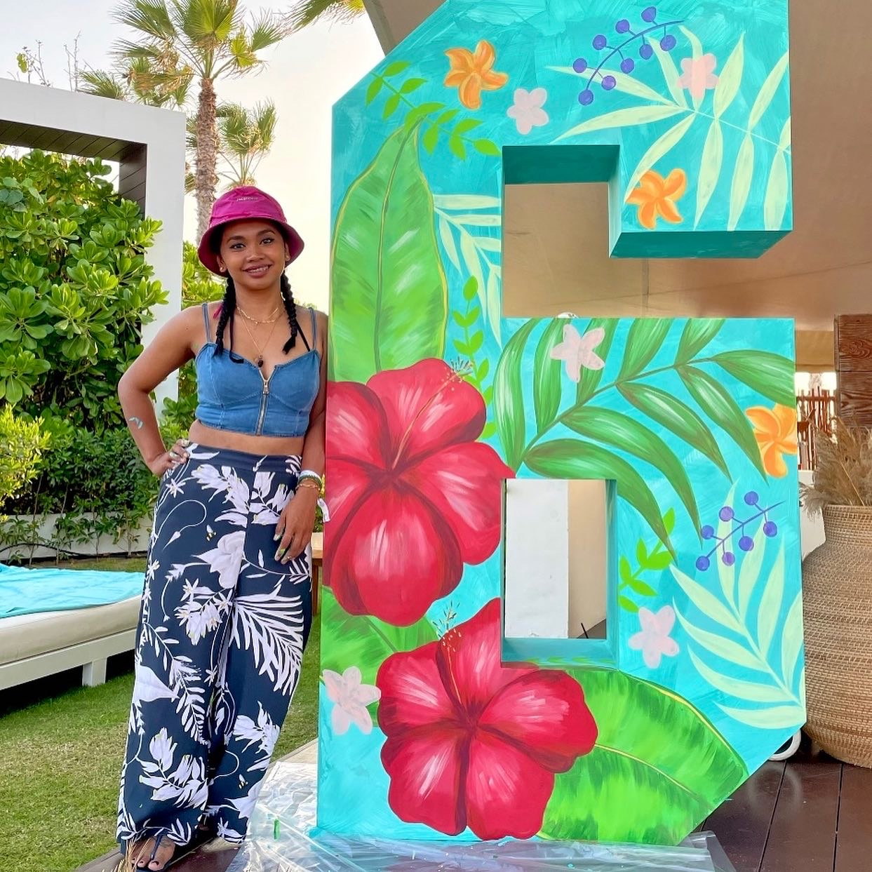 Ella beside the finished anniversary letters at Nikki Beach