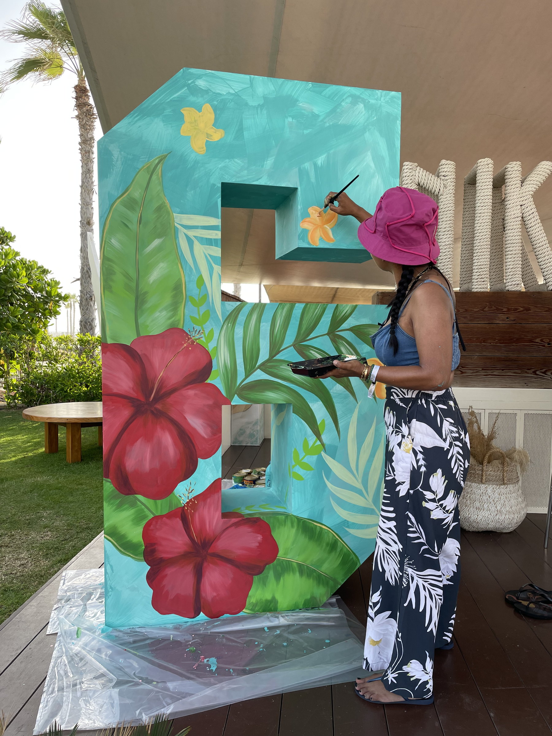 Painting the hibiscus letters live at Nikki Beach
