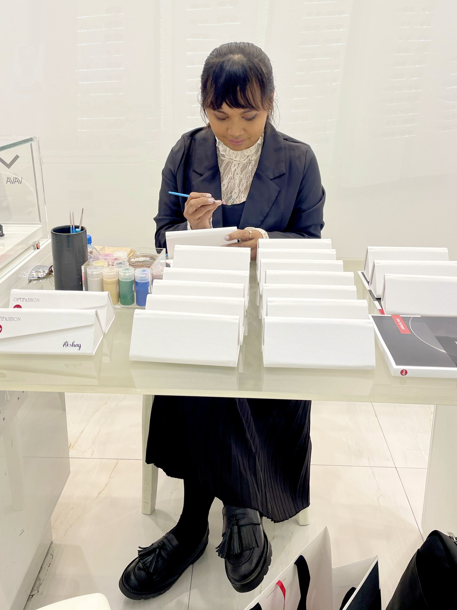 Ella lettering sunglass cases at the counter